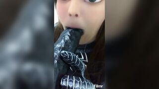 Spidergirl trying to deep throat a massive black dildo.