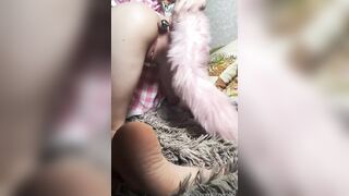 Teen plays with her holes and inserts her tail.