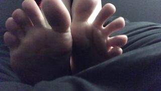 Slut playing with her huge feet.