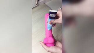 schoolgirl lubricates pink cock before sitting on it