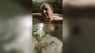 Orgasm in the hot tub playing with her pussy