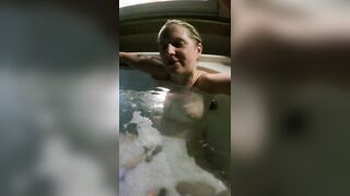 Orgasm in the hot tub playing with her pussy