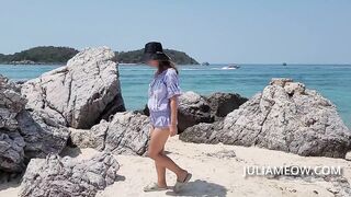 Bottomless girl walking on a public beach